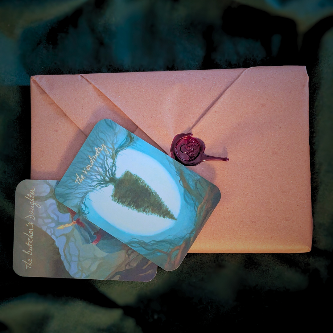Two trading cards on a wrapped book set with a red wax seal, against a dark green leafy background.